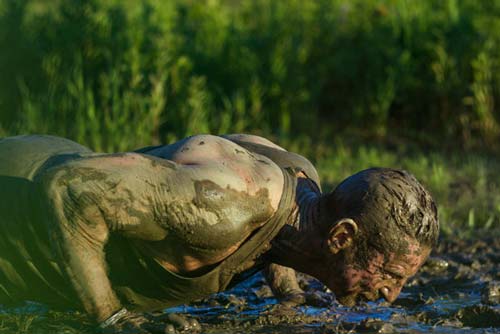 Man lying face down in the mud